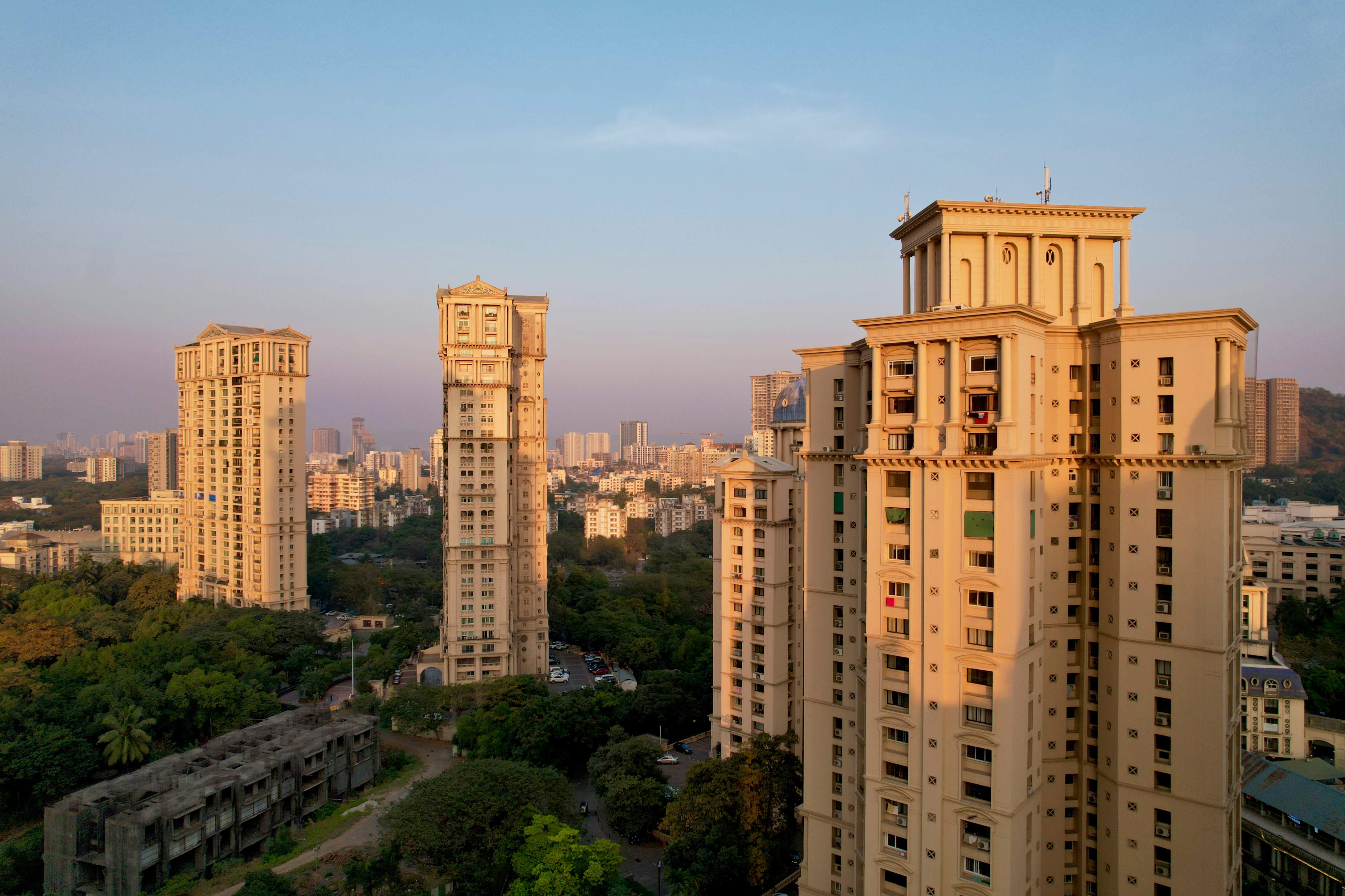 Modern apartment buildings under a clear blue sky, symbolizing the Indian housing market in 2026.
