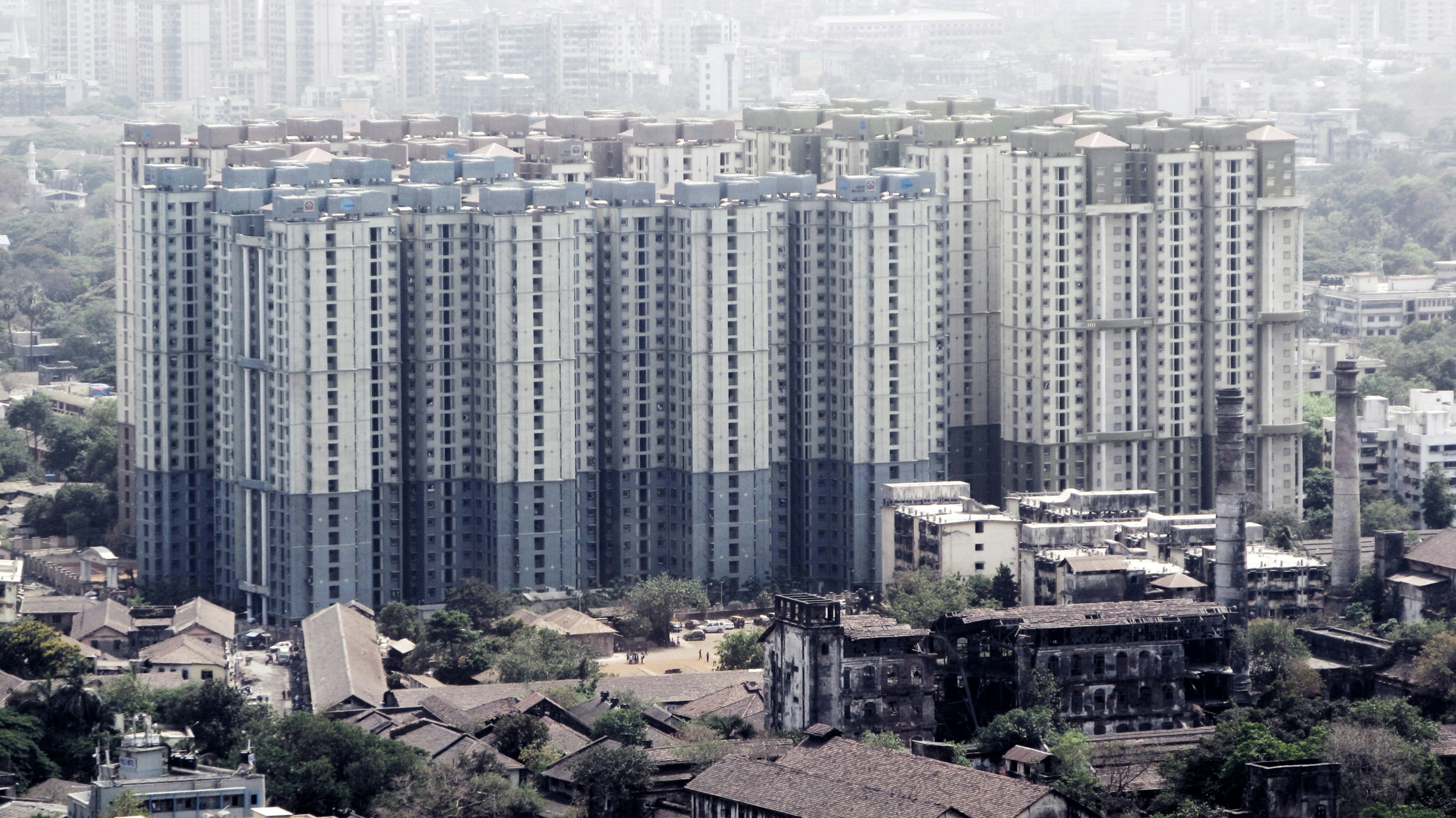 A modern apartment complex representing affordable housing initiatives in India.