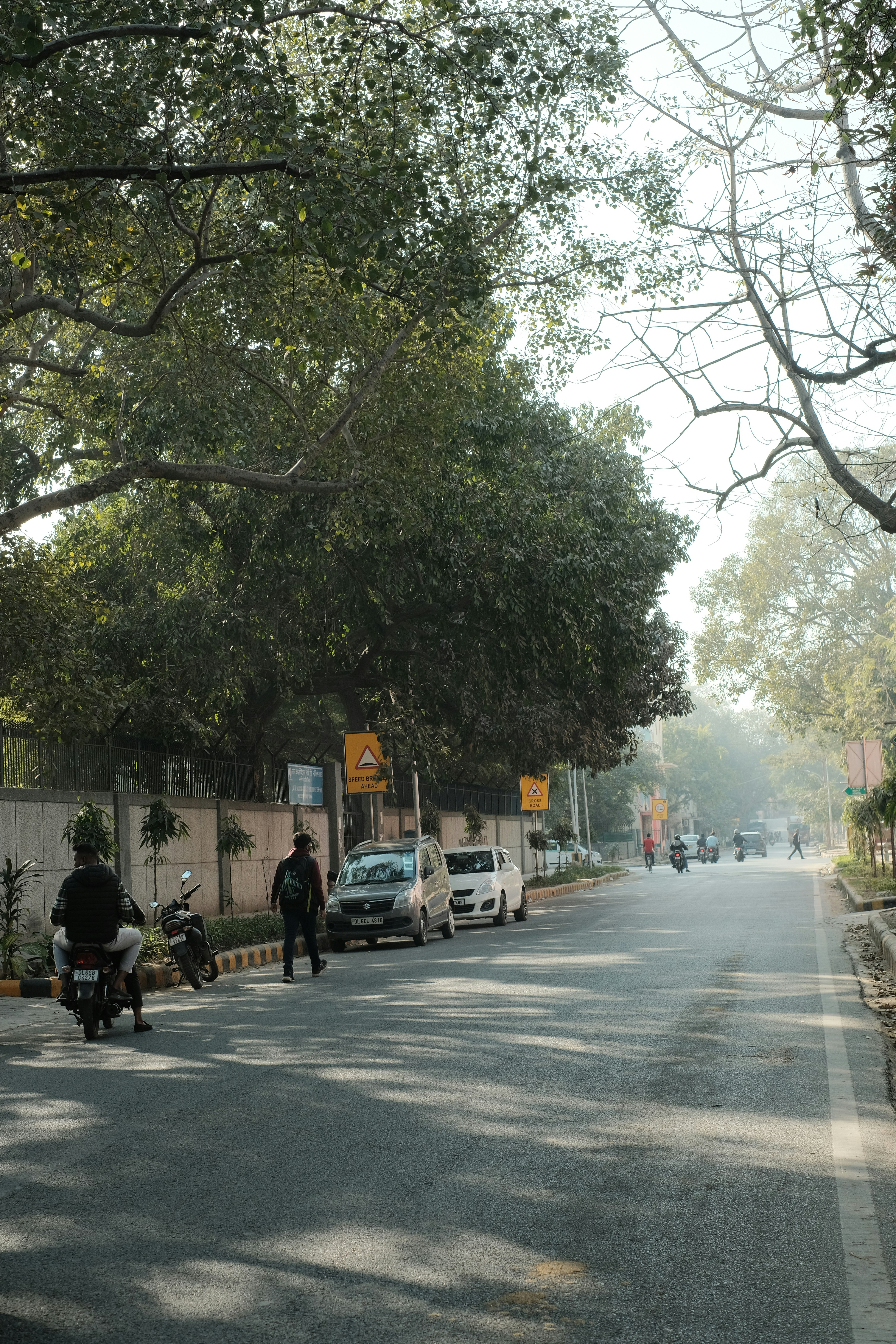 Cars parked in a Delhi residential neighborhood with marked slots